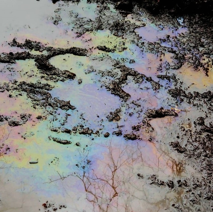 colours caused by oil in a muddy puddle